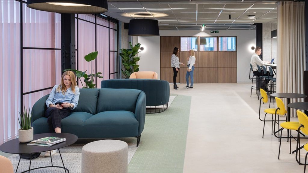 Myo Members work in the communal area at Myo 123 Victoria Street, featuring soft furnishings and breakout spaces.