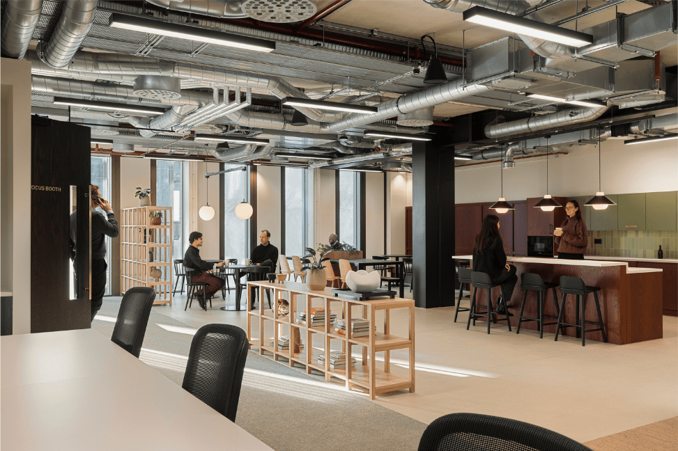 Myo Bankside's interior, featuring a kitchen area, communal seating and desks.