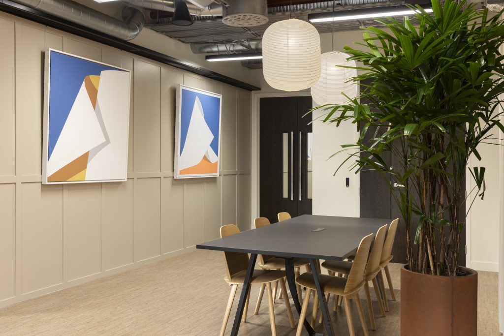 Communal space inside Myo Bankside with six-person meeting table and internal planting.