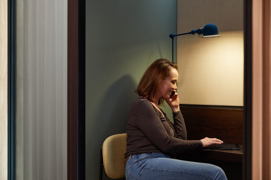 Woman on the phone in a private workspace.